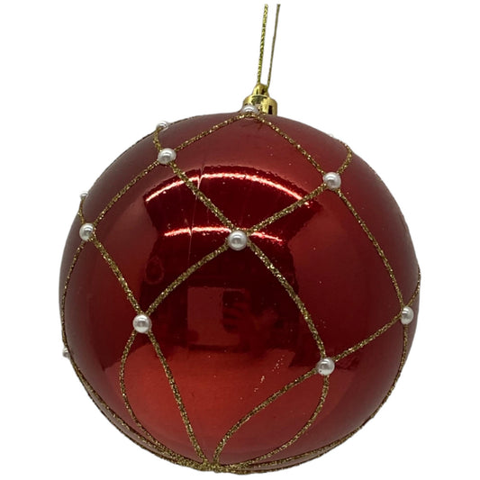Esfera roja brillante con detalles dorados y perlas